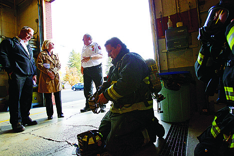 &lt;p&gt;JEROME A. POLLOS/Press Northern Lakes firefighters Chris Larson, second from right, and Jarrod Pitts remove their protective equipment Wednesday after a demonstration for Vicki Wilson, second from left, as Div. Chief Mike Mathers, left, and Chief Dean Marcus discuss the costs associated with the gear firefighters use. The demonstration was part of a educational tour for the public to learn why the fire department is requesting the $1.6 million permanent override levy.&lt;/p&gt;