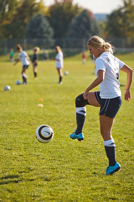<p>Alyssa Allen stops the ball during practice drill at Lake City High School.</p>