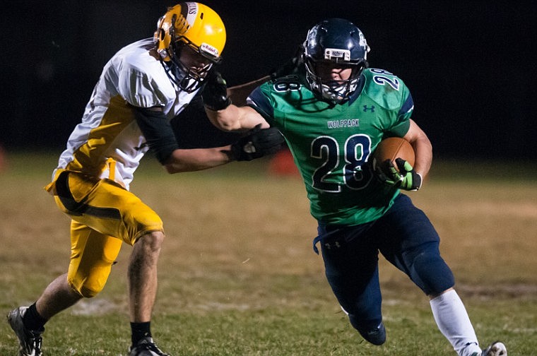 &lt;p&gt;Patrick Cote/Daily Inter Lake Glacier junior running back Aaron Mitchell (28) stiff arms a defender Thursday night during Glacier's matchup against Helena Capital at Legends Stadium Thursday, Oct. 18, 2012 in Kalispell, Montana.&lt;/p&gt;