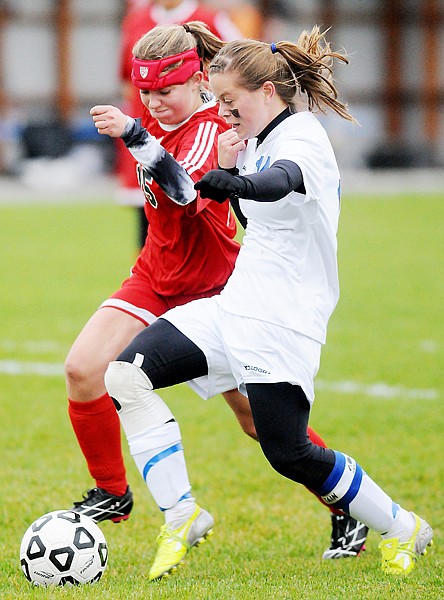 <p>Columbia Falls senior McKenzie Kiser (right) drives toward the
net under pressure from Loyola junior Caelin Miltko during their
Class A state soccer first-round playoff match on Saturday
afternoon in Columbia Falls.</p>