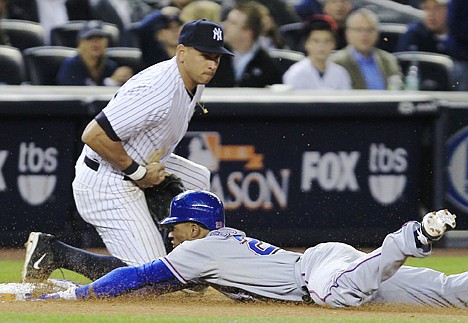 &lt;p&gt;Texas' Julio Borbon dives safely into third base as New York third baseman Alex Rodriguez takes the throw during Monday's game in New York.&lt;/p&gt;