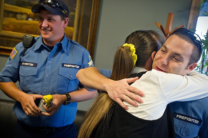 &lt;p&gt;Coeur d'Alene firefighter Eric Paul receives a hug from Linda Paullas after receiving an award Monday from the woman who nearly died five years ago after being stung by a bee on a camping trip. Firefighters Craig Etherton, left, and Capt. Matt Sowa (not pictured) also assisted in the rescue and received awards from Paullas.&lt;/p&gt;