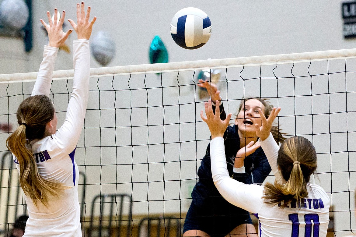 &lt;p&gt;JAKE PARRISH/Press Lake City's Tessa Sarff goes for the kill over Meg Woods, left, and Madison Stoddard of Lewiston during the 5A Region 1 championship game on Tuesday at Lake City High School.&lt;/p&gt;