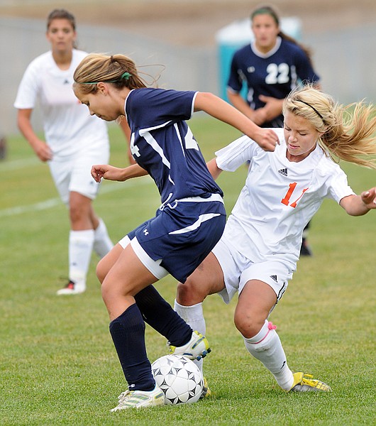 <p>Flatheads Jaclyn Rauthe (11) fights for possession of the ball
with Glaciers Abbe</p>
<p>Breeding during Thursday afternoons Western AA play-in
match.</p>