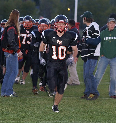 The Savage Horsemen charge onto the field for the Hot Springs homecoming, led by Trevor Brass.