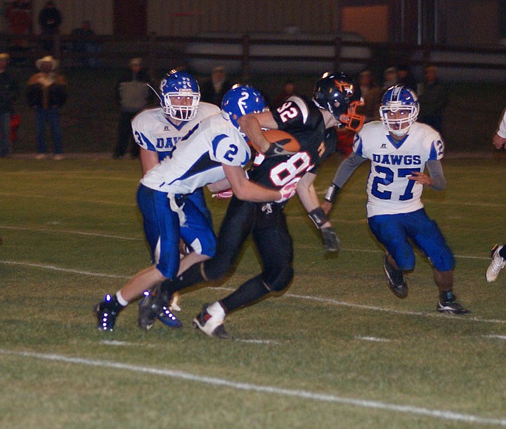 Tanner Ostrum tried to escape a tackle in the game last Friday.