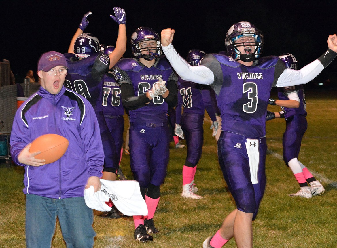 <p>CHARLO HIGH School QB Landers Smith celebrates with teammates and staff members after the Vikings scored a first-half touchdown in their 60-6 victory over Twin Bridges Friday at Charlo High School. With the victory, the Vikings secured the conference title and two home playoff games headed into their season-finale with crosstown rival Arlee High School Friday at Charlo High School. </p>
