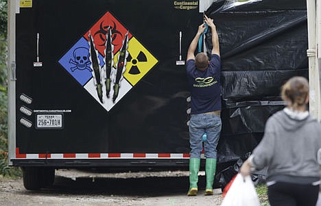 &lt;p&gt;A hazmat worker puts up a plastic sheet before starting to clean the apartment building of a hospital worker on Oct. 12 in Dallas.&#160;&lt;/p&gt;