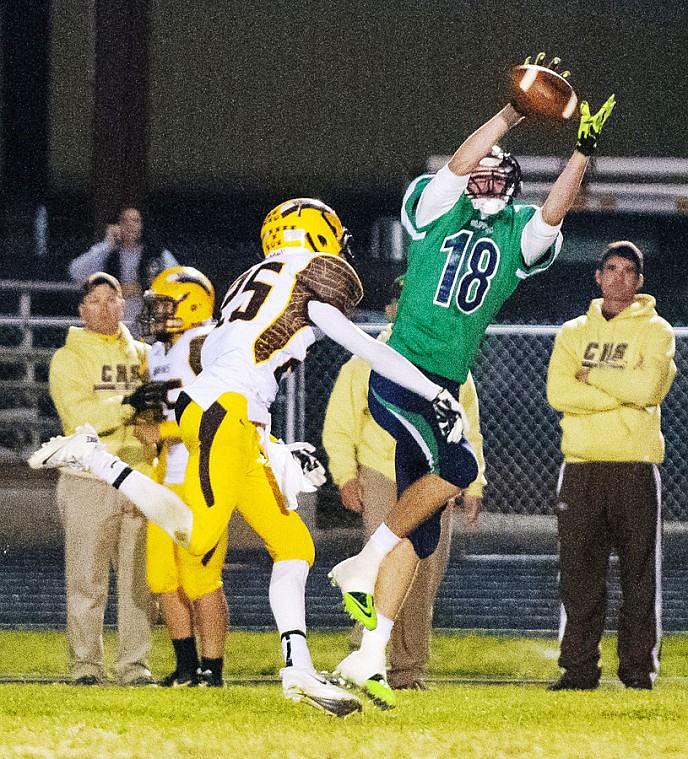 <p>Glacier junior wide receiver Sam McCamley (18) hauls in a pass near the sideline Friday night during Glacier game with Helena Capital at Legends Stadium.</p>