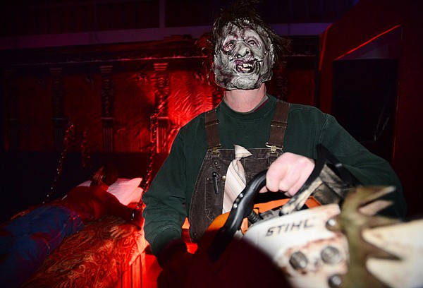 <p>Robin Collier revs up a chain saw to frighten guests of The Zone Haunted Hotel. (Brenda Ahearn/Daily Inter Lake)</p>