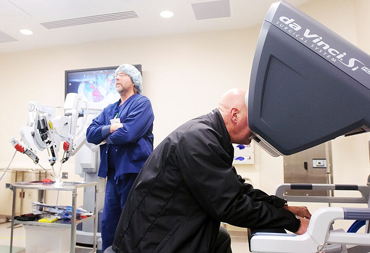 <p>Robotics coordinator Randy Mansfield watches as Mark Sanman, right, plays with a da Vinci Surgical System robot Tuesday afternoon during an open house for the new surgical suite at North Valley Hospital in Whitefish. (Patrick Cote/Daily Inter Lake)</p>