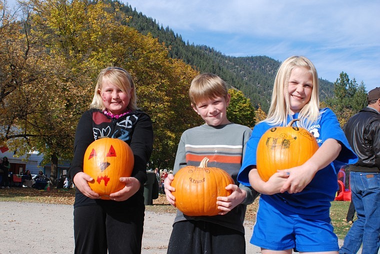 Clara Davis, Kaden Hill and Kearsten Hill display their prize-winning pumpkins, which they decorated during the event on Saturday.