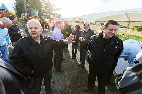 &lt;p&gt;Former Post Falls Mayor Clay Larkin, left, and Post Falls Police Chief Scot Haug mingle with business and community members Tuesday following a groundbreaking ceremony for a Greensferry Road overpass at Interstate-90 that will be construction over the coming months. During his service as mayor, Larkin was instrumental in the project planning process, some 20 years in the making.&lt;/p&gt;