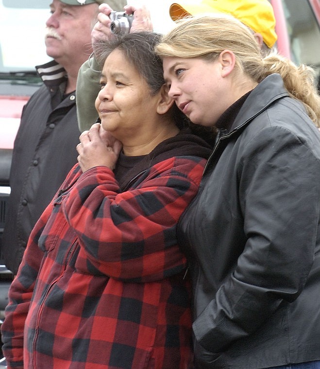 Sawbuck Saloon and Casino runner LeeAnn Quinby, right, leans on Karen Morton, a former Pancho Magoos waitress, as they watch the building being torn down Wednesday. In the back is Phil Helean, who had been the Sawbuck manager.