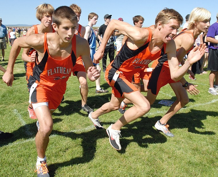 The Flathead boys varsity cross country team practices a start before the Flathead Invitational race at Kidsports Complex on Saturday, September 12.