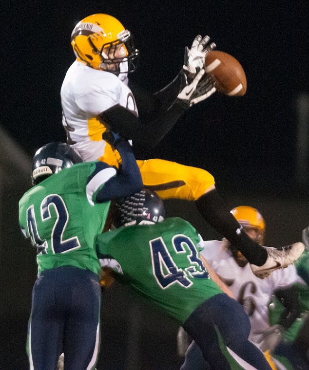 <p>Patrick Cote/Daily Inter Lake Helena Capital's (84) drops a pass as he is hit by Glacier's Brayden Nicholson (42) and Rial Gunlikson (43) Thursday night during Glacier's matchup against Helena Capital at Legends Stadium Thursday, Oct. 18, 2012 in Kalispell, Montana.</p>