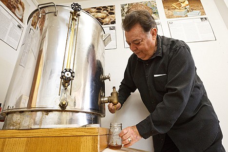 &lt;p&gt;Charles S. Williams, owner of The Bee Hive in Hayden, pours honey into a jar on Friday. The shop specializes in honey products and bee education.&lt;/p&gt;