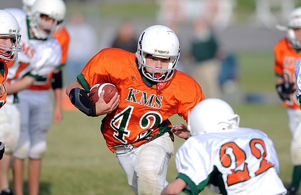 Jacob Ridgeway (42) tries to evade a tackle during the last game between two of the three Kalispell Middle School seventh grade football teams on Tuesday, October 12.