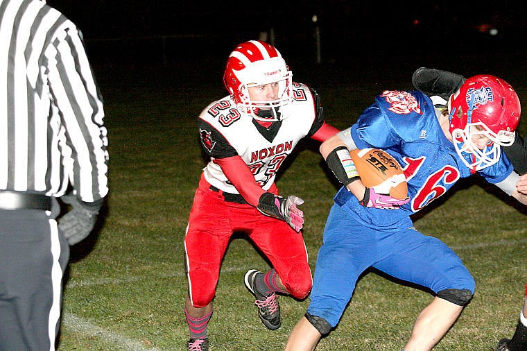 <p>Sophomore Jacob Mitchell attempts to tackle the Superior ball carrier in Friday's loss on the road.</p>