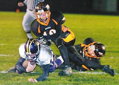 Flathead's Dylan MacGregor brings down Missoula Sentinel quarterback Garrett Graves to end the first half of Friday's Class AA football game. The tackle kept Graves from scoring a touchdown, and kept the game tied 0-0 at half time. Flathead eventually won the game 14-6. Chris Jordan/Daily Inter Lake