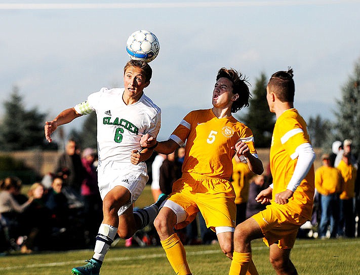 &lt;p&gt;Glacier's Colton Becker heads the ball to get past Helena Capital defenders at Glacier on Friday. The Wolfpack won on penalty kicks to earn a spot at the state tournament in Billings. (Aaric Bryan/Daily Inter Lake)&lt;/p&gt;