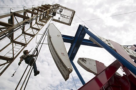 &lt;p&gt;Ben Shaw hangs from an oil derrick outside of Williston, N.D., in July 2011. U.S. oil output is surging so fast that the United States could soon overtake Saudi Arabia as the world's biggest producer. U.S. production of oil and other liquid hydrocarbons is on track to rise 7 percent in 2012 to an average of 10.9 million barrels per day. It's the fourth straight year of crude increases, and this year drillers are on track to post the biggest single year gain since 1951.&lt;/p&gt;