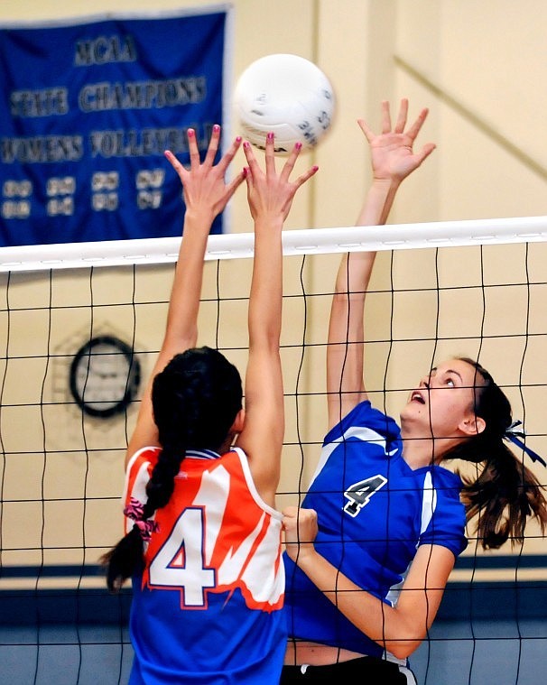 Stillwaters Katie Harrel (right) goes up for a spike at the net against Helena Christian Schools Caitlin Olson.