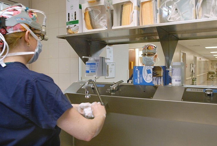 Dr. Melissa Hulvat scrubs up at The Surgery Center adjacent to the Bass Breast Center. Hulvat is co-director of the breast center.