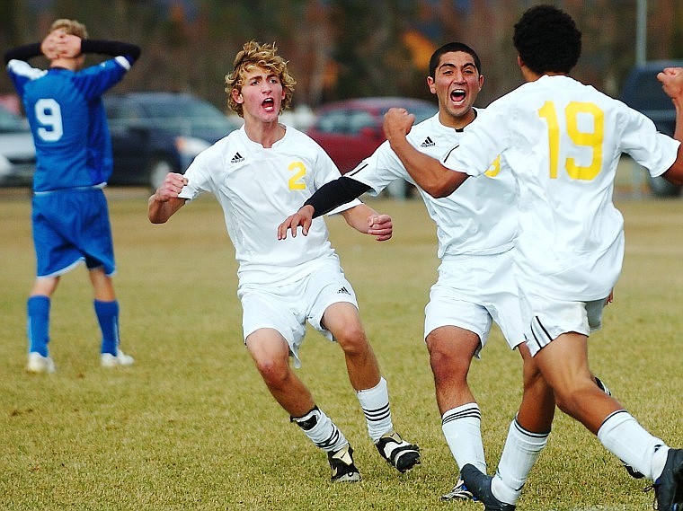 Whitefish's Taylor Thompson (2) and Cristian Saavedra celebrate with Anto Daoud (19) after Daoud netted the game winning goal with less than five minutes left in the second half against Corvallis Saturday afternoon.