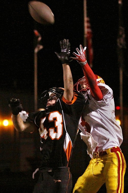 Flathead's Zach Diest jumps up in the end zone to deny Missoula Hellgate's Spencer Hale a touchdown reception in the thrid quarter of Friday evening's game at Legends Stadium.