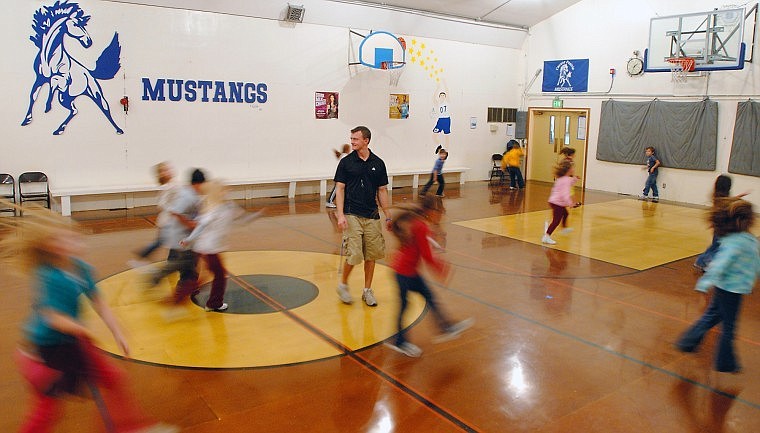 Cayuse Prairie School physical education teacher Chris Finberg watches second-grade students skip across the gym on Monday afternoon. Ballots are being sent today to voters in the Cayuse Prairie School District, asking them to approve a $1.95 million bond request to build a new gym and performing arts center for the school.