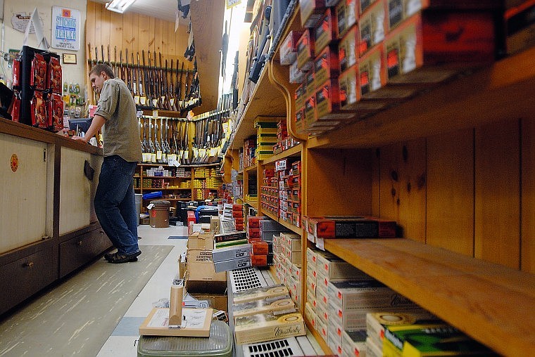 Sean Albrite waits to help customers in the gun section of Snappy Sport Senter on Thursday morning. Because of high demand for bullets, the store was out of .30-30 and .30-06 and other &#147;low-production&#148; calibers.