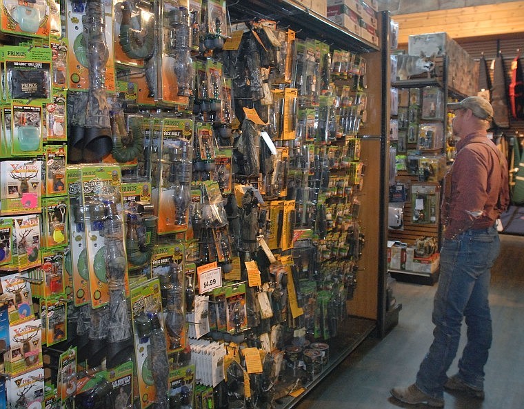 Matt Beam of Kalispell searches the &#147;call wall&#148; for his hunting needs at Sportsman and Ski Haus during lunch hour on Wednesday.