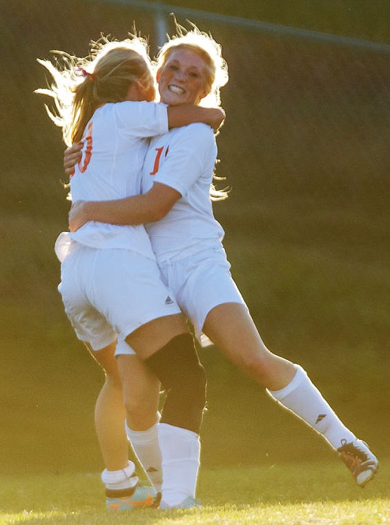 <p>Flathead junior Monica White (left) and senior Paige Birky celebrate the game-winning goal Thursday afternoon during Flathead's 3-2 playoff victory over Missoula Big Sky at Kidsports Complex.</p>