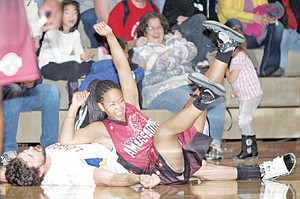 &lt;p&gt;Second quarter action finds Rotary Roundballer Jake Swartzendruber down for the count in the wrestling match with Harlem Ambassador Cherie Hughes Sunday at Ralph Tate Gymnasium.&lt;/p&gt;