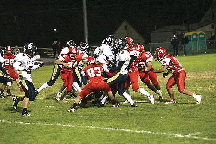 The Othello Huskies (in red) had enough defense to keep Selah out of the end zone enough times to win 38-17 on Friday.