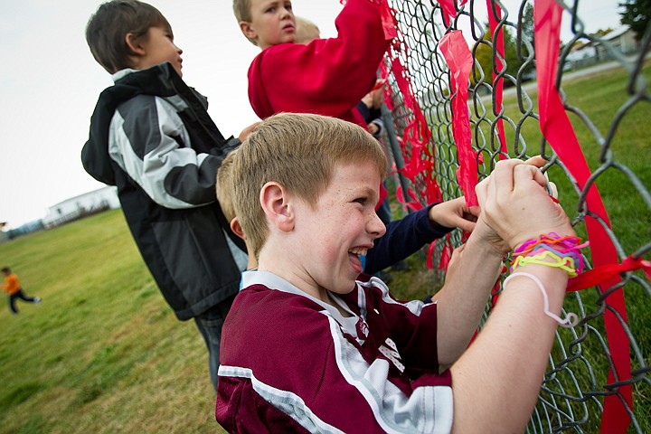 &lt;p&gt;SHAWN GUST/Press Tyson Pottenger, a second-grader at Seltice Elementary School in Post Falls, ties a ribbon to the chain link fence that borders the school yard Friday in preparation for Red Ribbon Week. There will be events throughout next week to encouraging students to remain drug free.&lt;/p&gt;