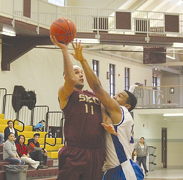 &lt;p&gt;Dennis Sangrey puts up a shot against a Malmstrom Air Force Base defender last year.&lt;/p&gt;