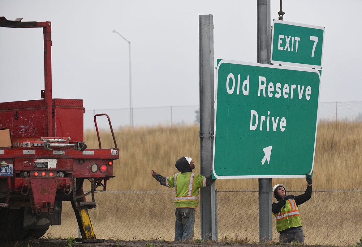 &lt;p&gt;Workers place an exit sign on the U.S. 93 Bypass on Tuesday. (Aaric Bryan/Daily Inter Lake)&lt;/p&gt;