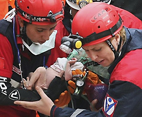 &lt;p&gt;Turkish rescuers carry Azra Karaduman, a two-week-old baby girl they have saved from under debris of a collapsed building in Ercis, Van, eastern Turkey, Tuesday, Oct. 25, 2011. The baby's mother, Semiha, was still alive, pinned next to a sofa inside the flattened building from where the child was rescued. A 7.2-magnitude earthquake toppled some 2,000 buildings in eastern Turkey, Sunday.(AP Photo)&lt;/p&gt;