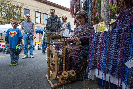 &lt;p&gt;Apple-Palooza attendees stop to watch Juaquetta Holcomb spin yarn at her booth during Apple-Palooza on Saturday morning. Apple-Palooza is the final Kootenai County farmers&#146; market of the year and featured fresh produce, live music, and apple treats from various businesses.&lt;/p&gt;