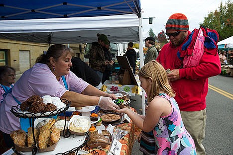 &lt;p&gt;Laurie Bailey from Lake City Cakes hands Rielan Montalvo, 7, a cupcake while her Dad Brad Montavalo pays during Apple-Palooza, Kootenai County&#146;s final farmers&#146; market of the season, on Satuday.&lt;/p&gt;