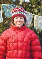 Purvis poses for a portrait with her Tibetan prayer flags in Whitefish.