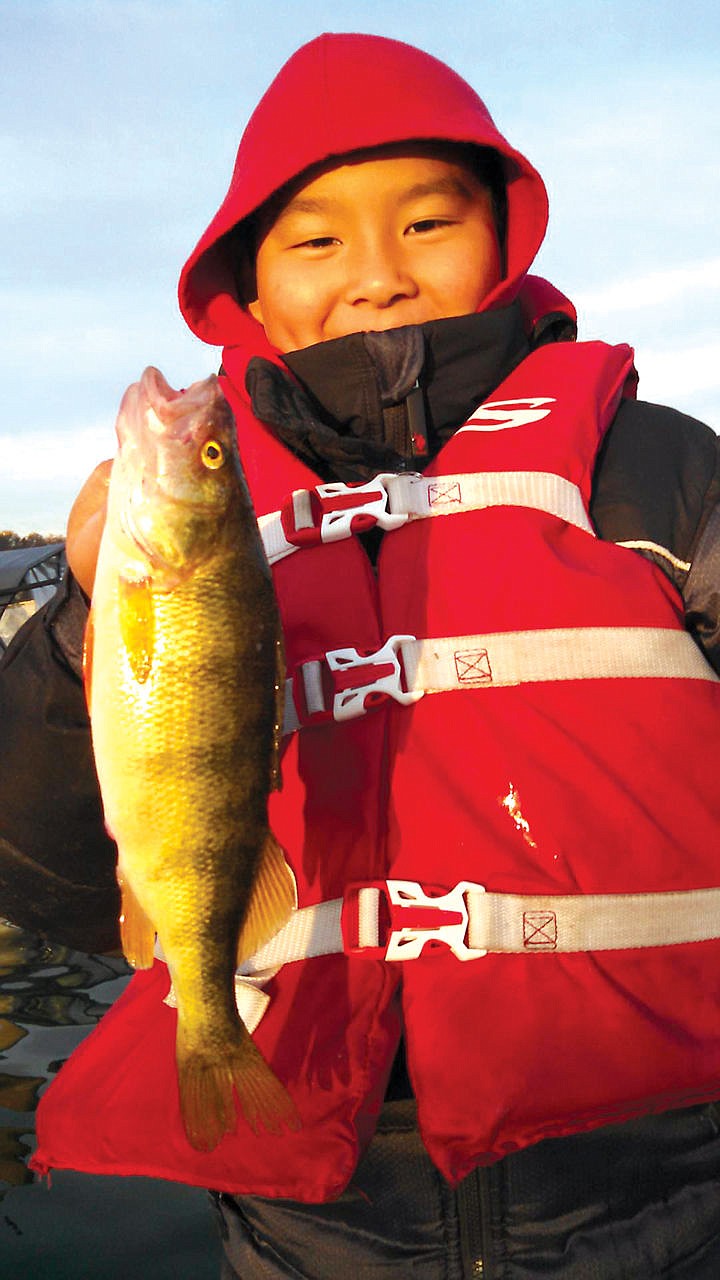 10 year old Benjamin Wu of Seattle, Wa enjoyed some excellent Perch and crappie fishing. Far left: Adam Wyble.