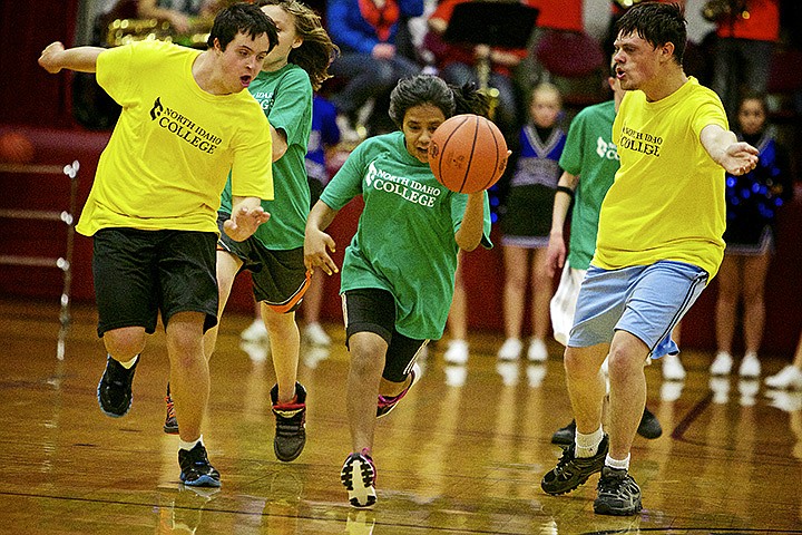 &lt;p&gt;JEROME A. POLLOS/Press Tia Vick, center, races between Ryan Sullivan, left, and C.J. Degrassenreid as she outruns their defense Wednesday during the first half of their game at the Special Need Basketball Extravaganza at North Idaho College.&lt;/p&gt;