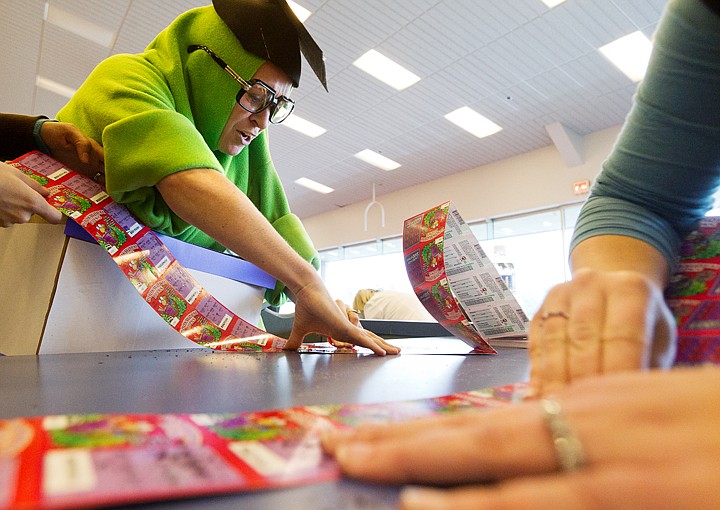 &lt;p&gt;SHAWN GUST/Press Allison Knoll, a language arts teacher at Lakeland Junior High School in Rathdrum, scratches a length of &quot;Bookworm Bucks&quot; dressed as a bookworm Thursday during the Idaho Lottery's annual event, the Jim Bruce Scratch for Schools. More than 450 schools participate in the event in Idaho this year, scratching some 160,000 tickets.&lt;/p&gt;