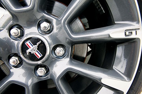 &lt;p&gt;This Aug. 31, 2011 photo, shows a wheel of a 2012 Ford Mustang GT California Special at the Maroone Ford of Miami dealership in Miami. Ford says it earned $1.6 billion in the third quarter, down 2 percent from a year ago. The drop was partly due to a charge for hedging on commodities like copper whose prices fell during the quarter. (AP Photo/Wilfredo Lee)&lt;/p&gt;