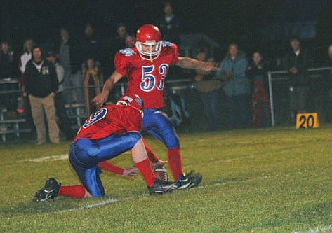 Tanner Coon holds the ball while Daylon Kuhl kicks it between the uprights against Loyola.