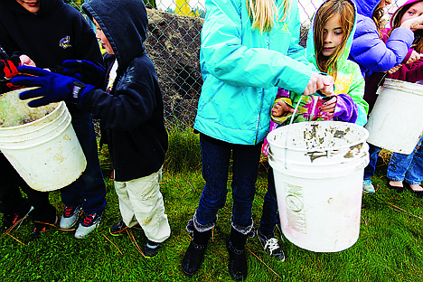 &lt;p&gt;Emily Raabe, a second-grade student at Hayden Meadows Elementary School, in tie-dye, is passed a bucket of soil Friday during an event related to a Friendly Farmers program that was funded from an EXCEL grant. The soil was passed down the human chain to raised beds, built by students, that will be used to grow vegetables to be distributed to Second Harvest food bank and for the school lunch program.&lt;/p&gt;