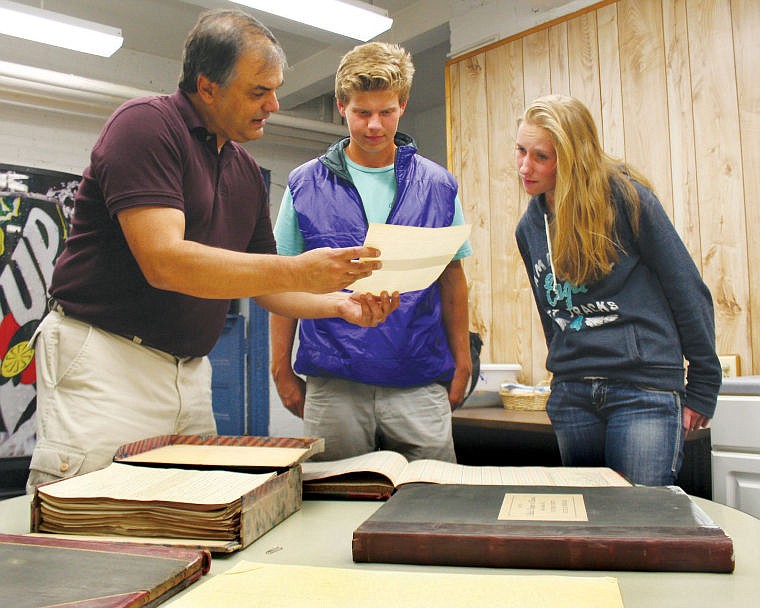 &lt;p&gt;Mike Kofford, outreach coordinator for Kalispell Public Schools, right, shows Flathead High School International Baccalureate seniors Haakon Sande and Eliza Diegel a teacher&#146;s contract from 1922 in the basement of the district&#146;s central office. At the time, the teacher made $1,392 for a year of service teaching primary grades, which is the same buying power as $19,378 today, according to the Bureau of Labor Statistics Consumer Price Index Inflation calculator. Sande and Diegel are researching district historical documents as part of Flathead&#146;s History in the Hallways project.&lt;/p&gt;